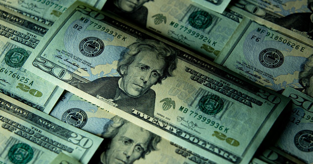Close-up of multiple US twenty dollar bills depicting wealth and finance.