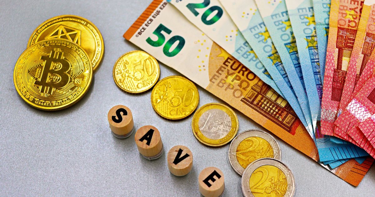 Euro banknotes and Bitcoin coins arranged with 'save' text for finance concept.