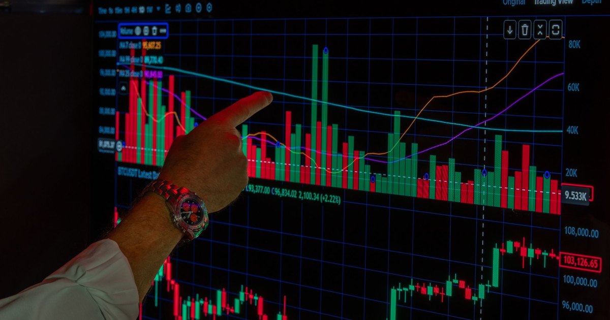 Close-up of a person analyzing Bitcoin market trends on a digital trading platform screen.