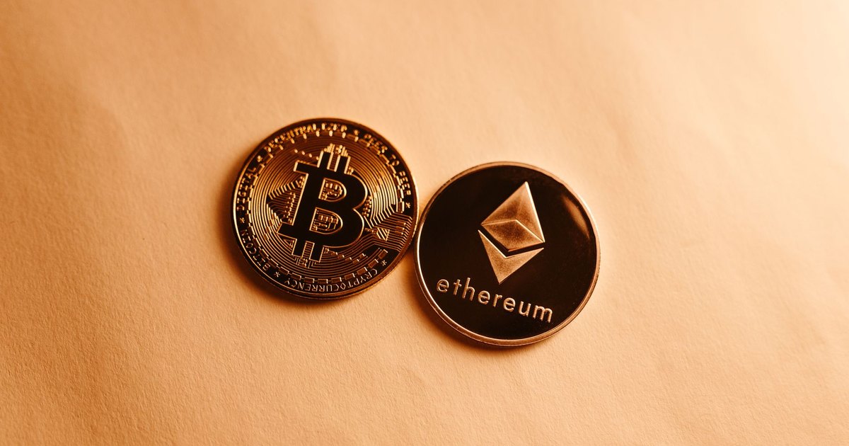 Bitcoin and Ethereum coins depicted on a soft yellow background for cryptocurrency and finance themes.
