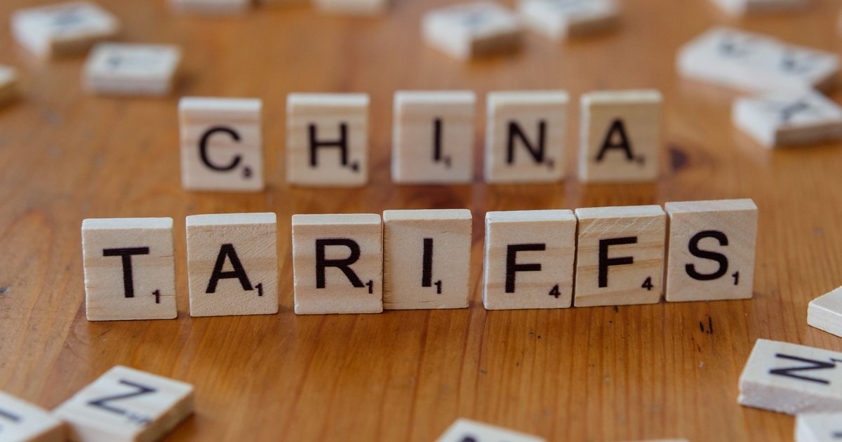 Scrabble tiles spelling 'China' and 'Tariffs' symbolize global trade issues.