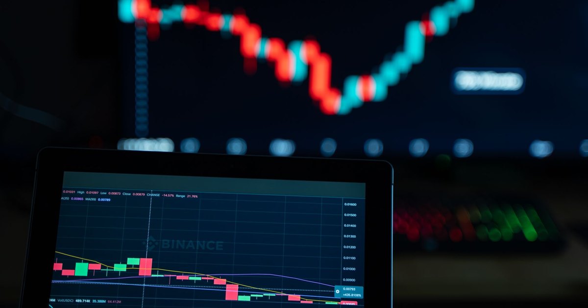 Detailed view of cryptocurrency trading charts on digital screens, showcasing market fluctuations.