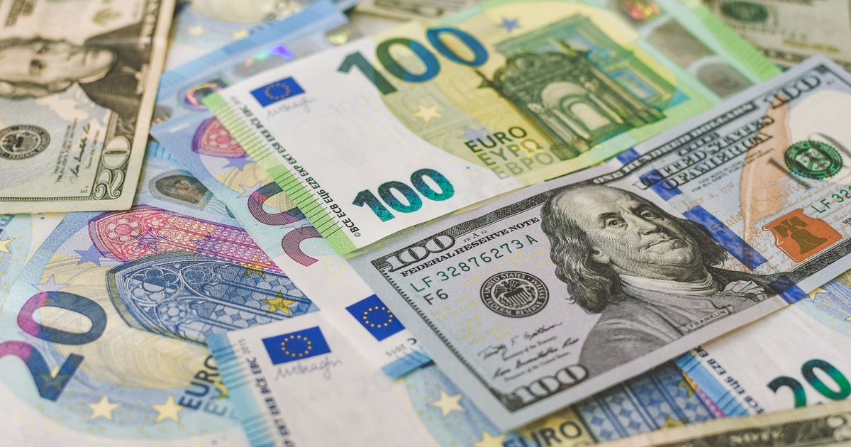 A detailed image of Euro and US dollar banknotes scattered, symbolizing global currency exchange.