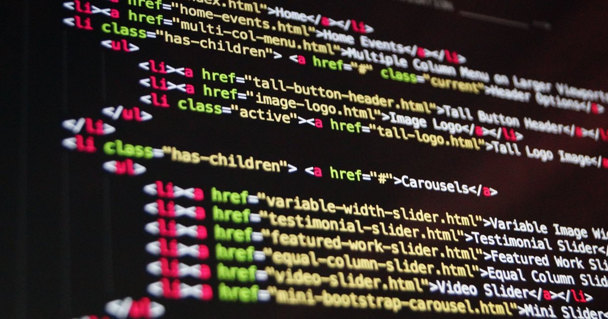 Close-up of HTML code highlighted in vibrant colors on a computer monitor.