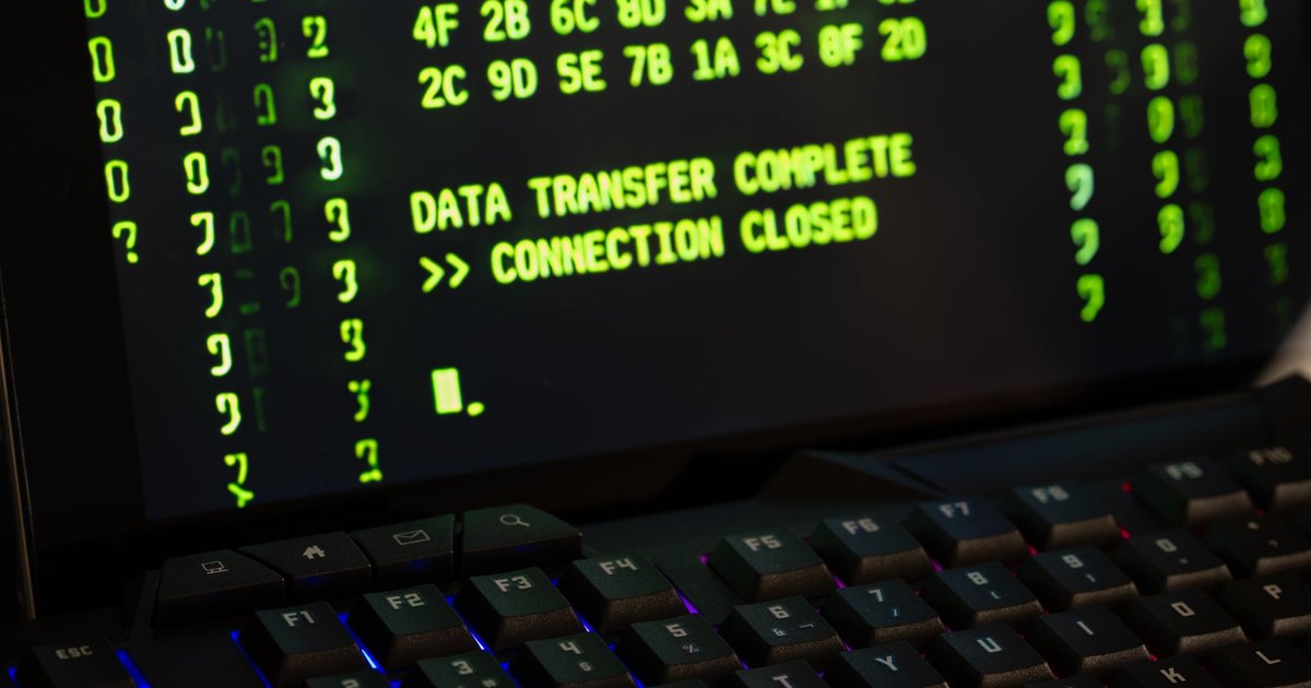Data transfer complete message displayed on a computer monitor with a keyboard underneath.