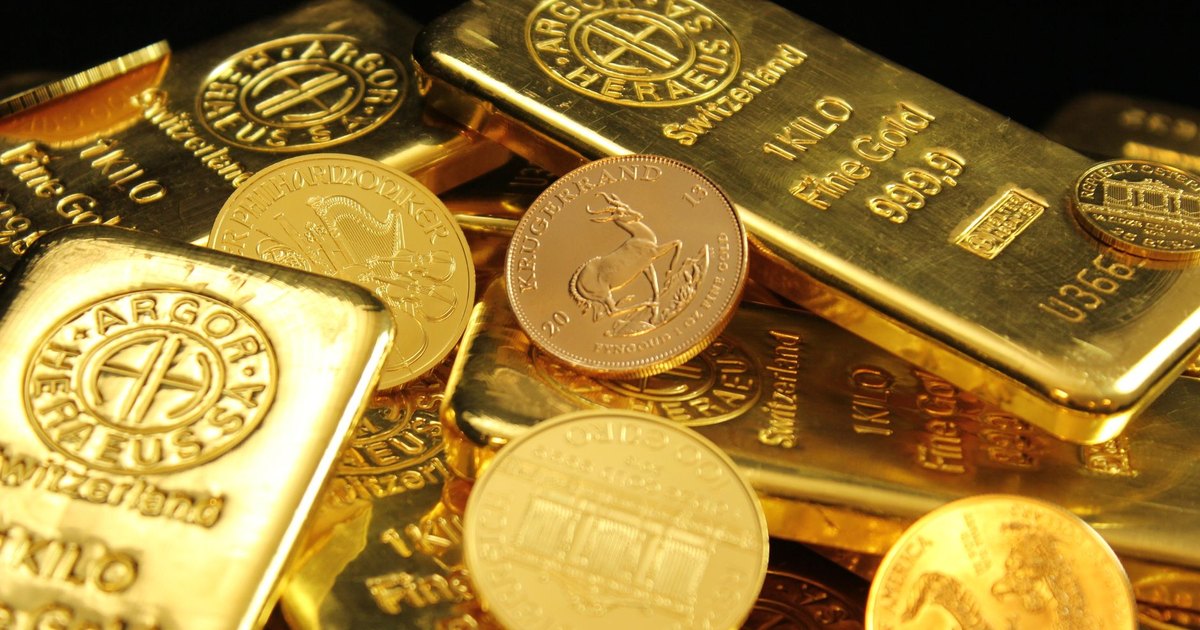 A detailed image of gold bars and coins symbolizing wealth and financial investment.
