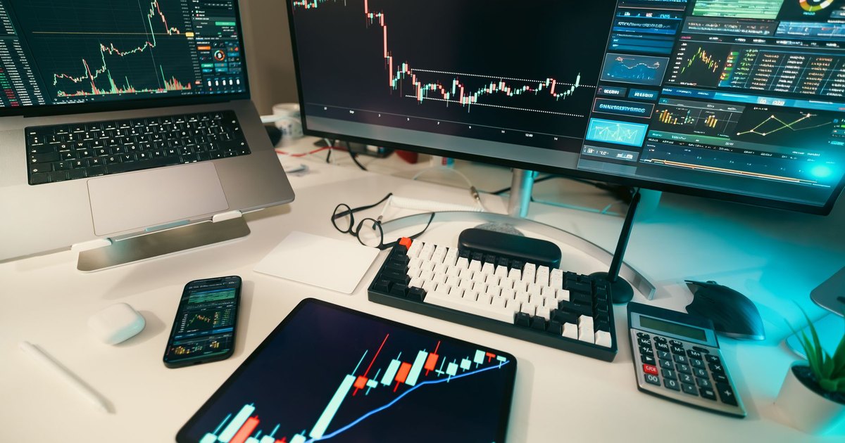 A modern trading desk with screens displaying financial charts and graphs, showcasing a digital analysis setup.