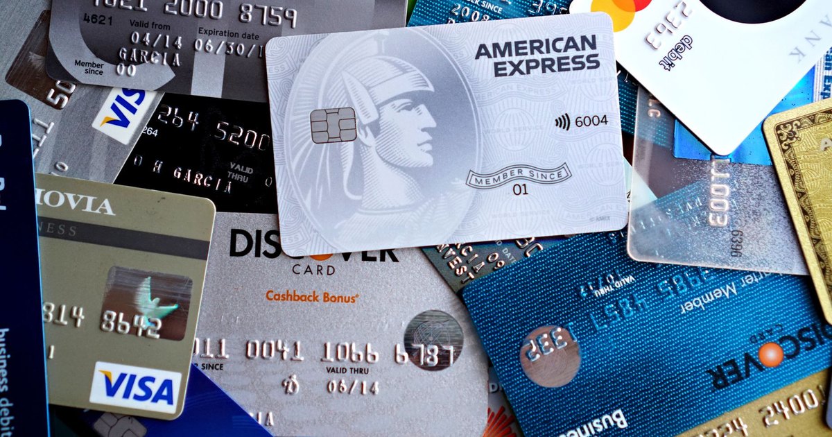 Close-up image of various credit and debit cards including Visa, MasterCard, American Express, and Discover.