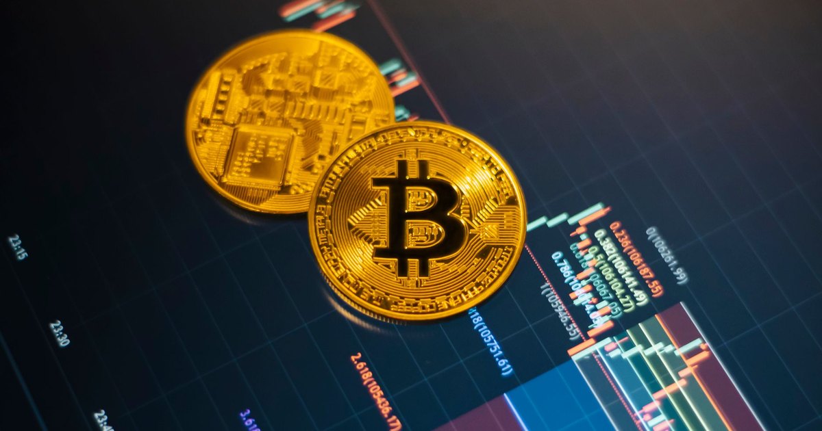 Golden Bitcoin coins on a digital stock market chart showcasing cryptocurrency trading.