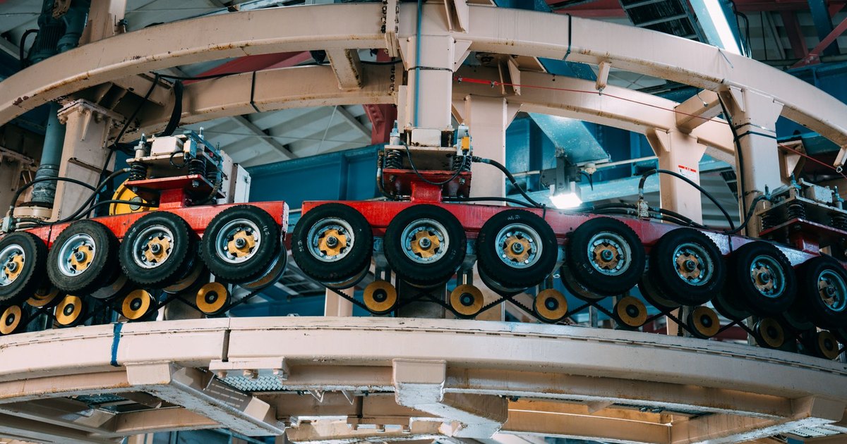 Close-up view of a complex industrial conveyor system inside a manufacturing facility.