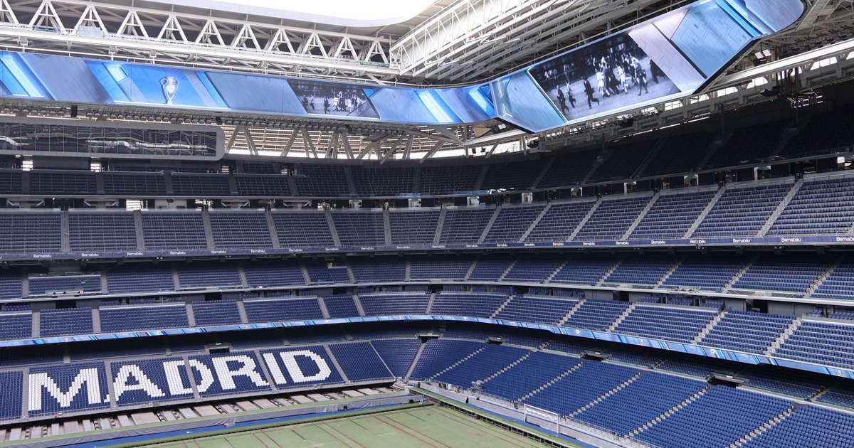 Explore the modern architecture of Santiago Bernabéu Stadium in Madrid, Spain, with its iconic branding.